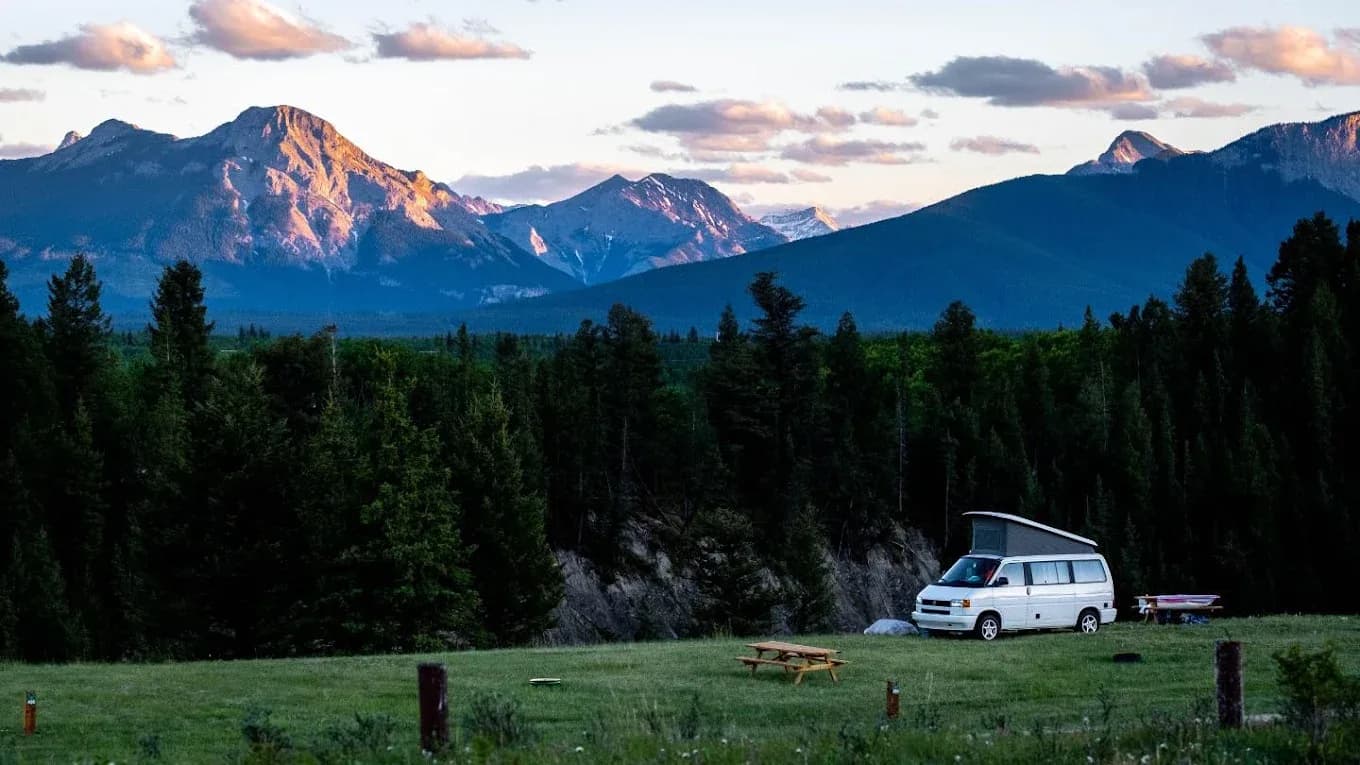 Camper van at Stoney Park with mountain sunset